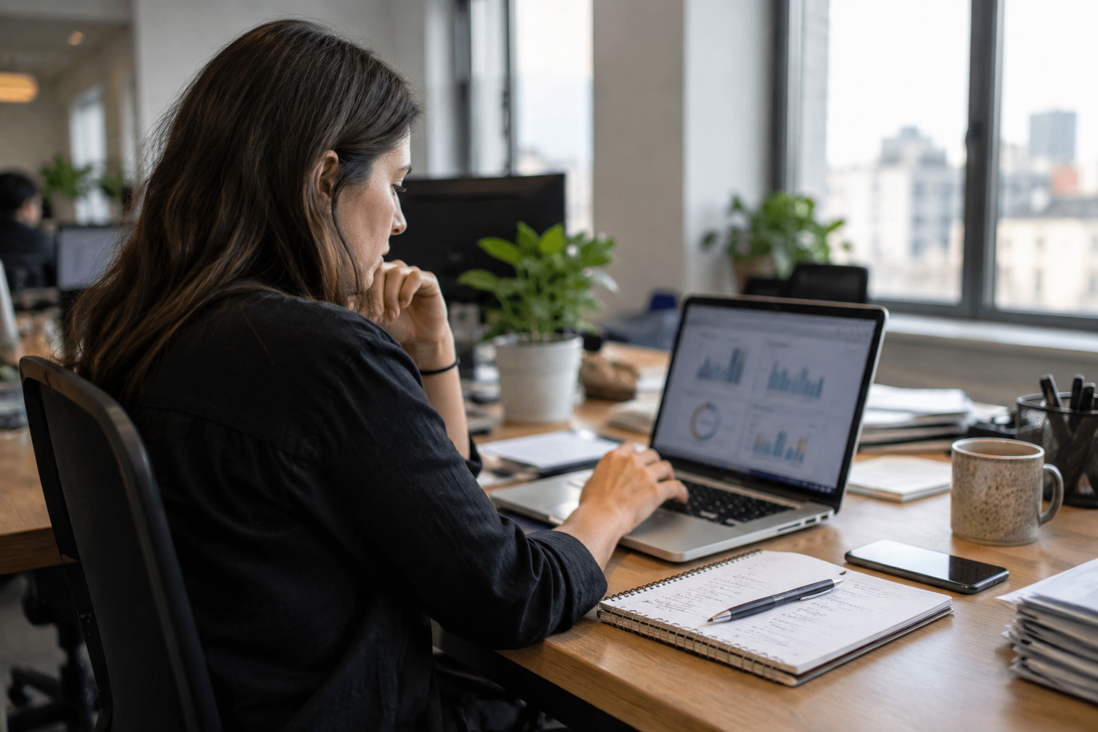 A marketing specialist reviewing campaign results at an ordinary office desk